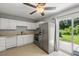 A kitchen with white cabinets, tile flooring, and stainless-steel appliances, offering a functional cooking space at 507 Stinson Dr # E8, Charleston, SC 29407