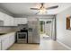 The kitchen has white cabinets and appliances, tiled floors, and sliding glass doors leading to a patio at 507 Stinson Dr # E8, Charleston, SC 29407