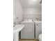 Utility room featuring a sink, stacked laundry machines, and storage shelving, making laundry tasks efficient and organized at 507 Stinson Dr # E8, Charleston, SC 29407