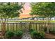 Charming backyard view of neighborhood lake framed by lush trees and manicured gardens at 529 Dunswell Dr, Summerville, SC 29486
