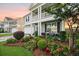 Inviting home exterior featuring a well-maintained lawn, colorful flowerbeds, and a cozy front porch at 529 Dunswell Dr, Summerville, SC 29486