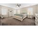 Bright main bedroom with white furniture, ceiling fan, and carpeted floors at 529 Dunswell Dr, Summerville, SC 29486