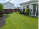 Well-manicured backyard with lush green grass, landscaped beds, and wooden fence at 558 Pendleton Dr, Moncks Corner, SC 29461