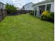 Well-maintained backyard with lush green grass, landscaping, and a wooden fence at 558 Pendleton Dr, Moncks Corner, SC 29461