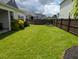 Large backyard with green grass, wooden fence, and lush landscaping at 558 Pendleton Dr, Moncks Corner, SC 29461