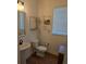 Chic half-bathroom with a pedestal sink, window, toilet, and decorative wall art and shelving at 558 Pendleton Dr, Moncks Corner, SC 29461