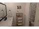 Bright bathroom featuring a white vanity, decorative shelves with towels and a decorative shower curtain at 558 Pendleton Dr, Moncks Corner, SC 29461