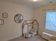 Light and airy bedroom with a toddler bed and plush pillows next to a window at 558 Pendleton Dr, Moncks Corner, SC 29461