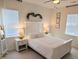 Well-lit bedroom featuring a white bed set, plush carpet, and accent lighting at 558 Pendleton Dr, Moncks Corner, SC 29461