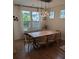 Dining area with a large wooden table and modern lighting, creating a cozy space to share a meal at 558 Pendleton Dr, Moncks Corner, SC 29461