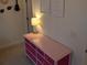 Bright bedroom featuring a pink dresser with gold accents and decorative wall art at 558 Pendleton Dr, Moncks Corner, SC 29461