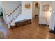 Bright entryway featuring hardwood floors, a staircase, decorative wall art, and stylish furniture at 558 Pendleton Dr, Moncks Corner, SC 29461
