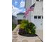 Charming home exterior with stone pathway, lush landscaping, and an American flag at 558 Pendleton Dr, Moncks Corner, SC 29461