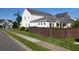 Exterior view of a home featuring a fenced yard, green grass and well-maintained surroundings at 558 Pendleton Dr, Moncks Corner, SC 29461