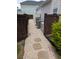 Side yard featuring stone pathway, fencing, and the home's AC Units at 558 Pendleton Dr, Moncks Corner, SC 29461