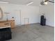 Spacious garage with work bench, white walls, concrete floor and a door to outside at 558 Pendleton Dr, Moncks Corner, SC 29461