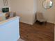 Hallway featuring wood floors, white walls, with a grey accent chair and desk at 558 Pendleton Dr, Moncks Corner, SC 29461