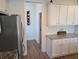 Bright kitchen with white cabinets and granite countertops, plus stainless steel refrigerator and wine rack at 558 Pendleton Dr, Moncks Corner, SC 29461