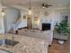 Cozy living room with a fireplace, hardwood floors, and plenty of natural light from large windows at 558 Pendleton Dr, Moncks Corner, SC 29461