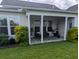 Inviting covered patio with comfortable seating, plants, and views of the backyard at 558 Pendleton Dr, Moncks Corner, SC 29461