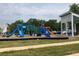 Community playground with blue slides and green climbing structure, offers fun and recreation for residents at 558 Pendleton Dr, Moncks Corner, SC 29461