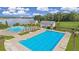 Aerial view of community pool area with lap pool, lounge chairs, and lakeside recreational area at 558 Pendleton Dr, Moncks Corner, SC 29461