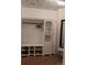 Spacious walk-in closet with custom shelving, hardwood floors, and decorative wallpaper at 558 Pendleton Dr, Moncks Corner, SC 29461