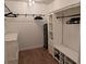 Spacious walk-in closet with a dresser, custom built-ins and hardwood floors at 558 Pendleton Dr, Moncks Corner, SC 29461