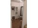 Walk-in closet with custom built-in shelving, seating, and hardwood floors at 558 Pendleton Dr, Moncks Corner, SC 29461