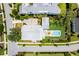 Stunning aerial view of the home showcasing its backyard pool and patio in a lush landscape at 566 Wading Pl, Daniel Island, SC 29492
