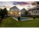 Expansive backyard featuring a pool, manicured lawn, outdoor seating area, and beautiful sunset views at 566 Wading Pl, Daniel Island, SC 29492