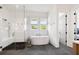 A bright and modern bathroom featuring a soaking tub and a glass-enclosed shower at 566 Wading Pl, Daniel Island, SC 29492
