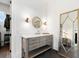 Bathroom featuring a vanity with a sink, decorative mirrors, and a wall lighting fixture at 566 Wading Pl, Daniel Island, SC 29492