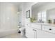Bright bathroom featuring a white vanity, marble countertop, framed mirror, and subway tile shower at 566 Wading Pl, Daniel Island, SC 29492