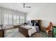 Serene bedroom with hardwood floors, desk, and large windows providing natural light at 566 Wading Pl, Daniel Island, SC 29492