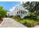 Charming three-story home featuring a welcoming front porch, landscaped yard, and a paved driveway at 566 Wading Pl, Daniel Island, SC 29492