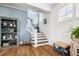 Bright foyer with hardwood floors, staircase, and decorative accents, creating an inviting entrance at 566 Wading Pl, Daniel Island, SC 29492