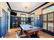 Game room featuring a pool table, built-in bar, hardwood floors and classic trim at 566 Wading Pl, Daniel Island, SC 29492