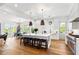 Bright open kitchen with an island, counter seating, modern appliances, and hardwood flooring at 566 Wading Pl, Daniel Island, SC 29492