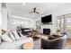 Bright and airy living room featuring hardwood floors, a fireplace, comfortable seating, and ample natural light at 566 Wading Pl, Daniel Island, SC 29492