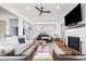 Bright open concept living room featuring a fireplace, views of the stairway, and access to the backyard at 566 Wading Pl, Daniel Island, SC 29492
