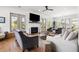 Inviting living room with a fireplace, hardwood floors, comfortable sofas, and multiple doors to the exterior at 566 Wading Pl, Daniel Island, SC 29492
