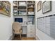Efficient office space with built-in shelving and drawers and a dedicated space for a computer at 566 Wading Pl, Daniel Island, SC 29492