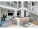 Inviting outdoor bar area with seating, TV, and stairs leading to the upper level deck at 566 Wading Pl, Daniel Island, SC 29492