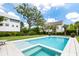 In-ground swimming pool with spa, large green lawn, and luxury homes in the background at 566 Wading Pl, Daniel Island, SC 29492