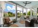 Outdoor covered porch with blue ceiling and fan with seating and views of the pool at 566 Wading Pl, Daniel Island, SC 29492