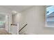A clean hallway with light walls, staircase and wood-look flooring at 615 Du Bois Dr, Johns Island, SC 29455