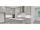 Bright kitchen with gray cabinets, stainless appliances, island and stylish pendant lighting, creating an inviting space at 615 Du Bois Dr, Johns Island, SC 29455
