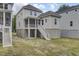 View of backyard with stairs to screened porch and the house's exterior at 619 Du Bois Dr, Johns Island, SC 29455