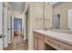 Bathroom vanity with wood cabinets and light countertop, leading to a hallway and rooms at 700 Daniel Ellis Dr # 3108, Charleston, SC 29412